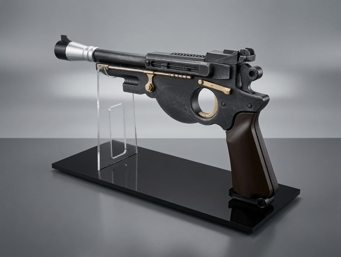 Black and gold futuristic gun model on a stand against a gray background