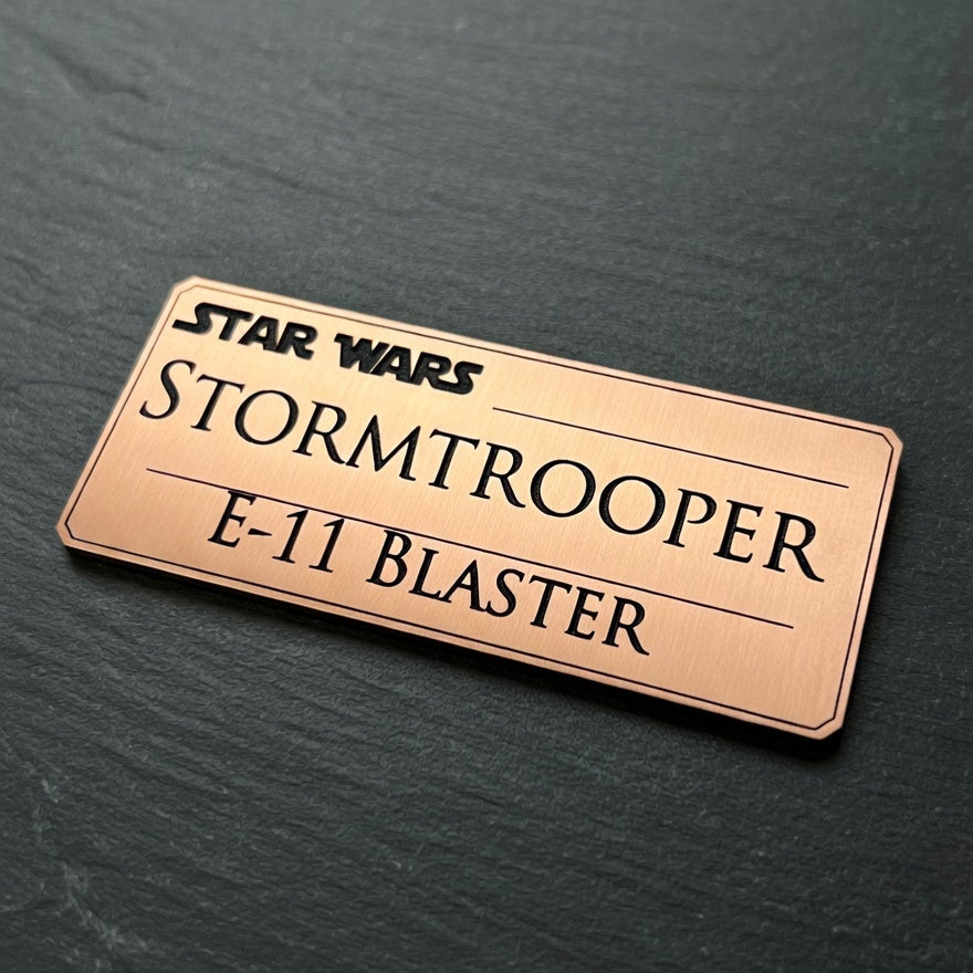 Star Wars Stormtrooper E-11 Blaster nameplate on a dark surface