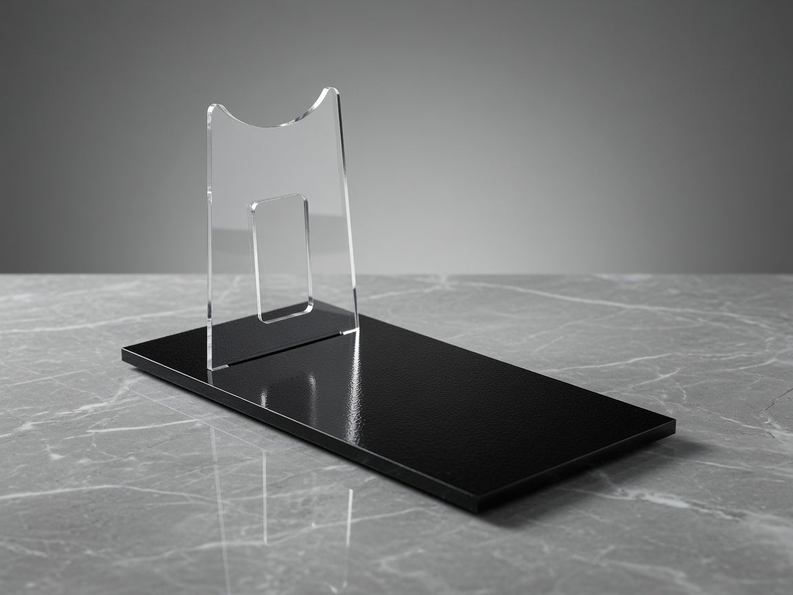 DT-12 Greedo blaster replica on clear acrylic display stand with polished black base